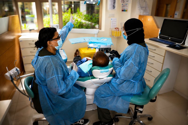 Dental students treating a patient at the RAKMHSU dental clinic